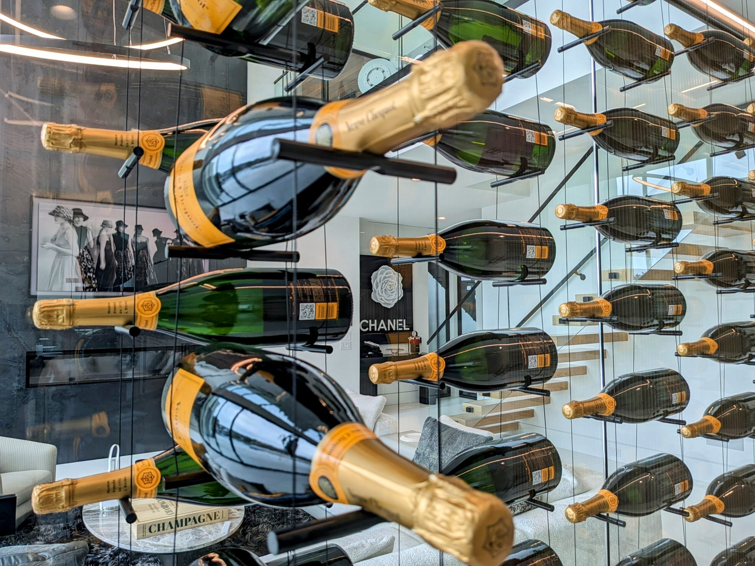 Bottles on black cable wine racks, a Thanksgiving wine rack idea for holiday hosting